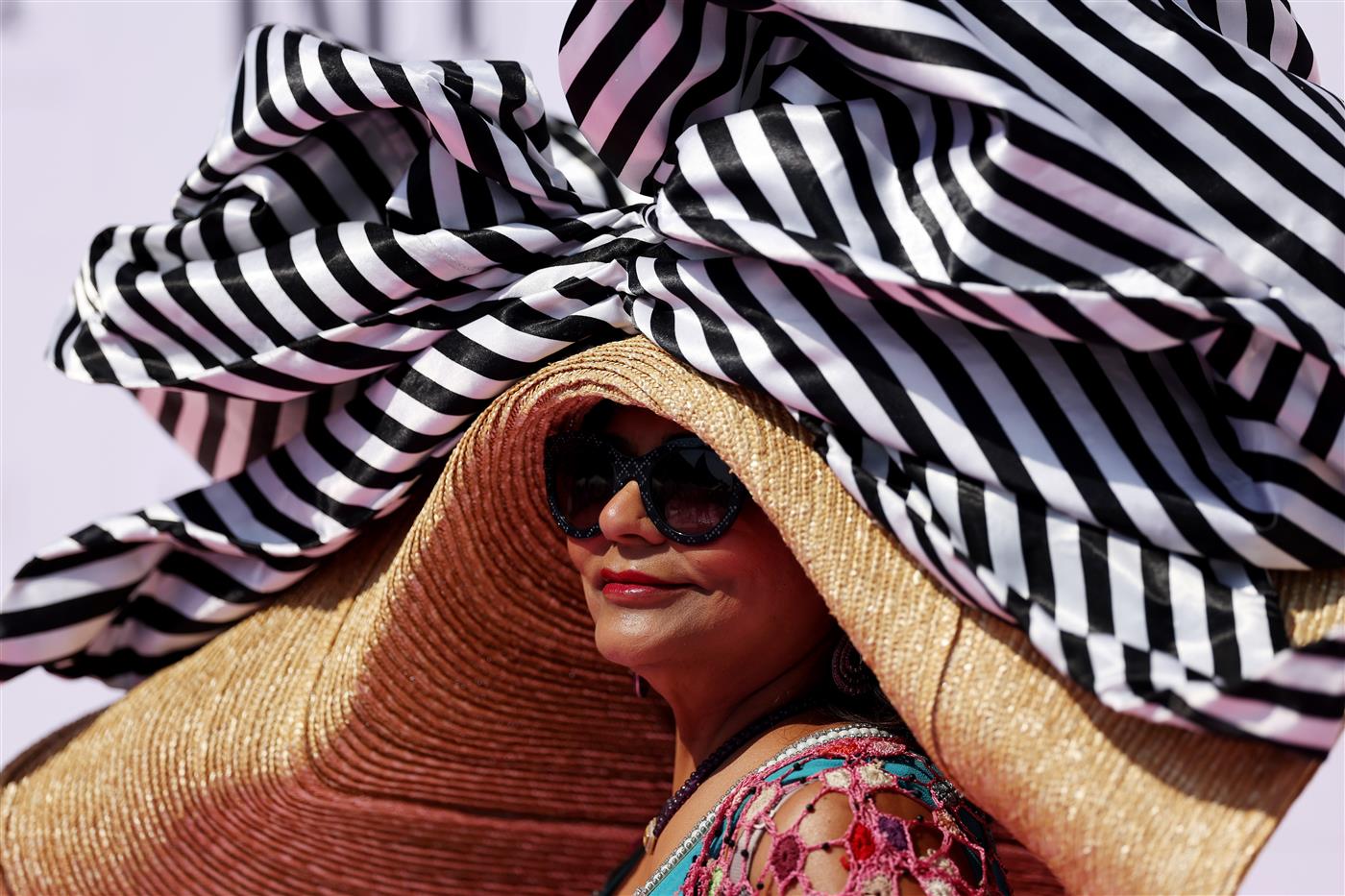 DUBAI, UNITED ARAB EMIRATES - MARCH 25: A racegoer looks on during the Dubai World Cup at Meydan Racecourse on March 25, 2023 in Dubai, United Arab Emirates. (Photo by Christopher Pike/Getty Images)