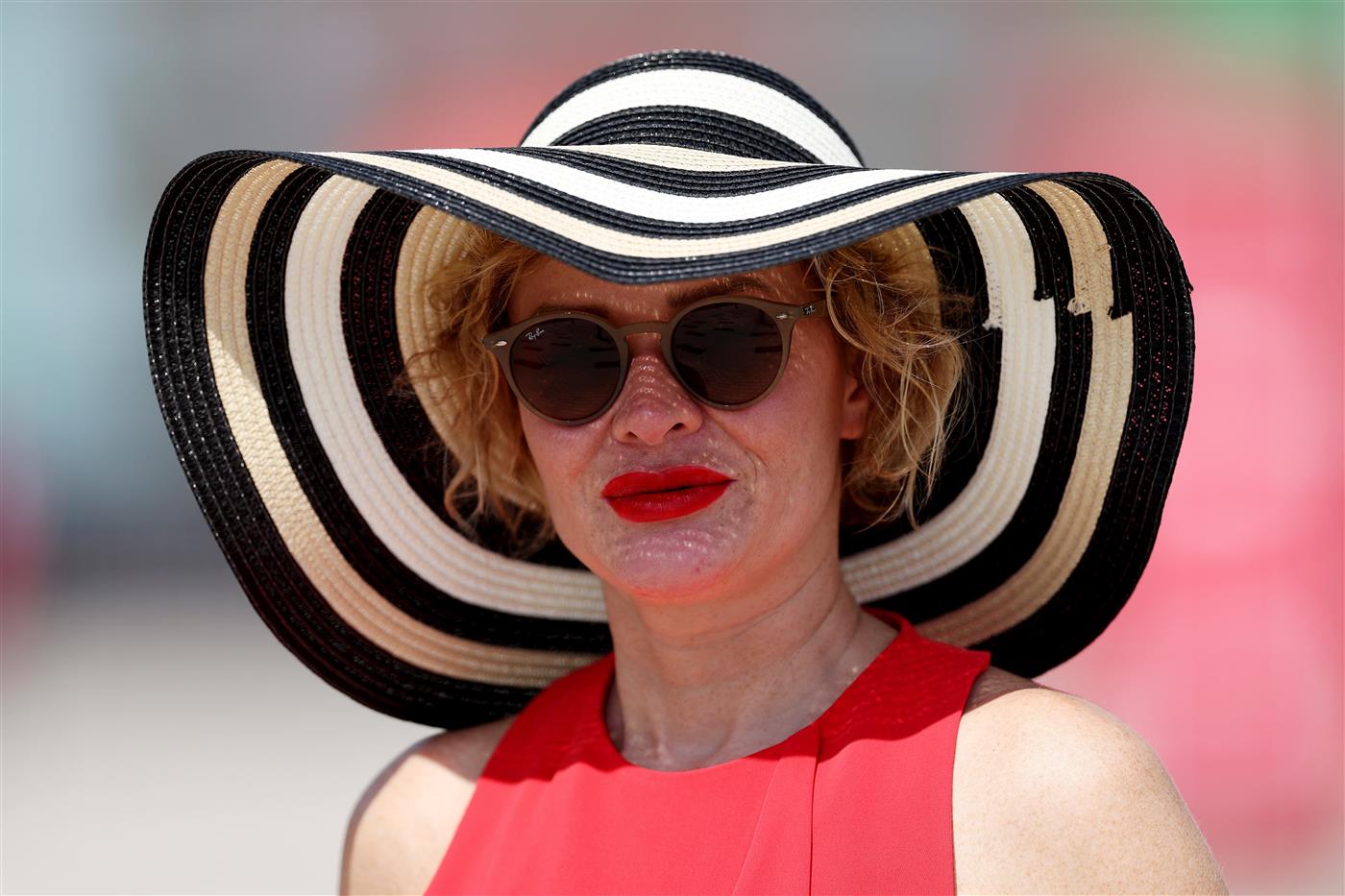 DUBAI, UNITED ARAB EMIRATES - MARCH 25: A racegoer looks on during the Dubai World Cup at Meydan Racecourse on March 25, 2023 in Dubai, United Arab Emirates. (Photo by Christopher Pike/Getty Images)