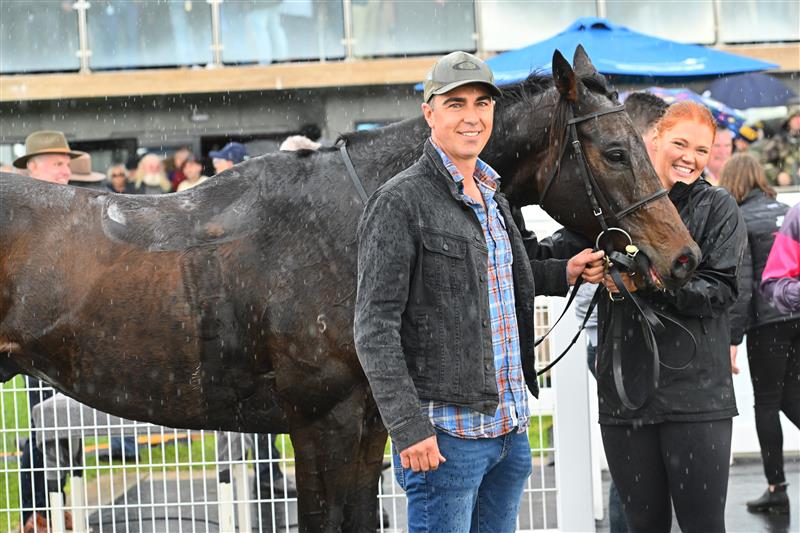 WARRNAMBOOL, AUSTRALIA - MAY 02: Trainer Symon Wilde poses with Britannicus after winning Race 6, the 3yb Fm Brierly Steeplechase, during Brierly Steeplechase day at Warrnambool Racing Club on May 02, 2023 in Warrnambool, Australia. (Photo by Vince Caligiuri/Getty Images)