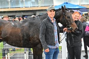 WARRNAMBOOL, AUSTRALIA - MAY 02: Trainer Symon Wilde poses with Britannicus after winning Race 6, the 3yb Fm Brierly Steeplechase, during Brierly Steeplechase day at Warrnambool Racing Club on May 02, 2023 in Warrnambool, Australia. (Photo by Vince Caligiuri/Getty Images)