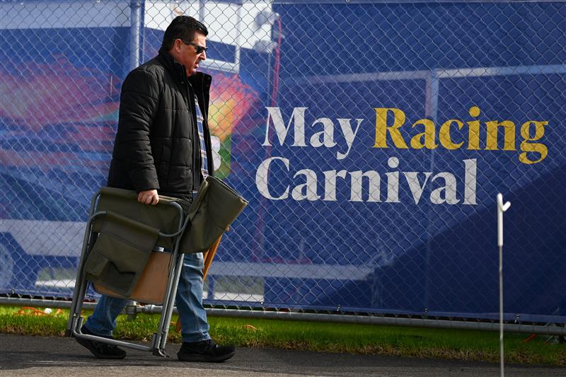 WARRNAMBOOL, AUSTRALIA - MAY 03: A spectator arrives with a chair during Galleywood Hurdle day at Warrnambool Racing Club on May 03, 2023 in Warrnambool, Australia. (Photo by Morgan Hancock/Getty Images)