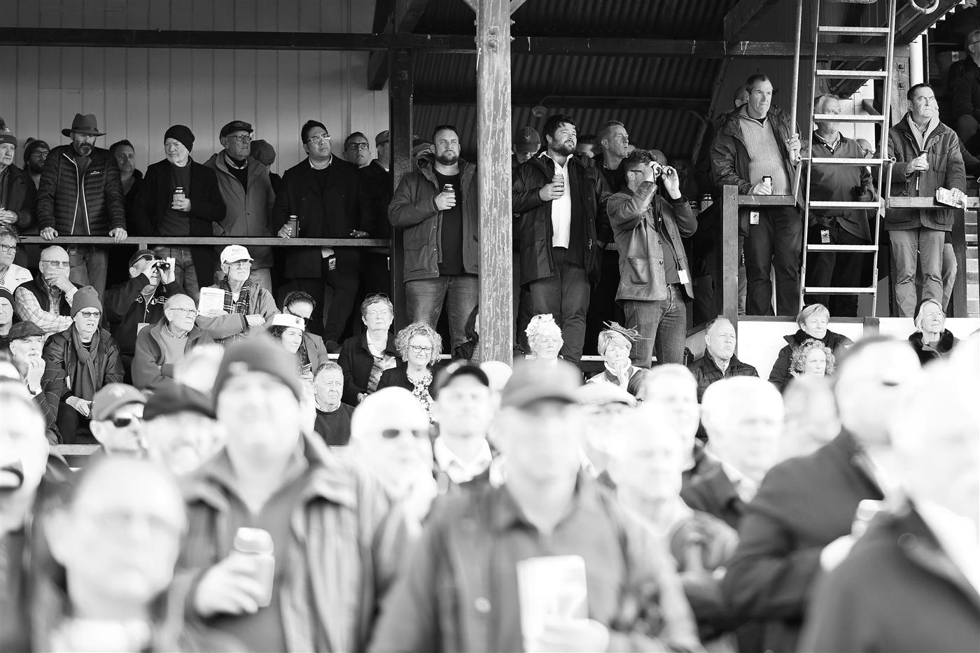 WARRNAMBOOL, AUSTRALIA - MAY 03: (EDITORS NOTE: Image has been converted to black and white.) Crowds watch on during Galleywood Hurdle day at Warrnambool Racing Club on May 03, 2023 in Warrnambool, Australia. (Photo by Morgan Hancock/Getty Images)