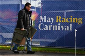WARRNAMBOOL, AUSTRALIA - MAY 03: A spectator arrives with a chair during Galleywood Hurdle day at Warrnambool Racing Club on May 03, 2023 in Warrnambool, Australia. (Photo by Morgan Hancock/Getty Images)