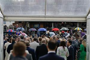 CHESTER, ENGLAND - MAY 11: Racegoers look on as runners pass at Chester Racecourse on May 11, 2023 in Chester, England. (Photo by Alan Crowhurst/Getty Images)