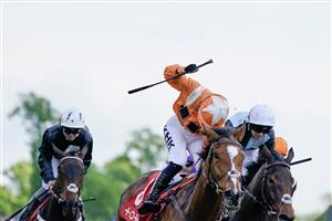CHESTER, ENGLAND - MAY 12: Saffie Osborne riding Metier (L, orange) win The tote Chester Cup at Chester Racecourse on May 12, 2023 in Chester, England. (Photo by Alan Crowhurst/Getty Images)