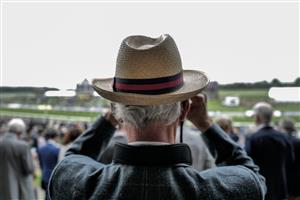 YORK, ENGLAND - MAY 18: A racegoer watches the action at York Racecourse on May 18, 2023 in York, England. (Photo by Alan Crowhurst/Getty Images)