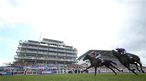 EPSOM, ENGLAND - JUNE 03: Auguste Rodin ridden by Ryan Moore (orange and blue silks) wins The Betfred Derby during Derby Day at Epsom Downs Racecourse on June 03, 2023 in Epsom, England. (Photo by Warren Little/Getty Images)