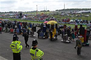 Police officers monitor the front of the grandstand where the bookmakers operate as racegoers arrive on the second day of the Epsom Derby Festival horse racing event in Surrey, southern England on June 3, 2023. (Photo by JUSTIN TALLIS / AFP) (Photo by JUSTIN TALLIS/AFP via Getty Images)