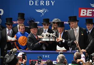 Owner of Auguste Rodin, Michael Tabor (C) and other connections at the trophy presentation after winning the Derby on the second day of the Epsom Derby Festival horse racing event in Surrey, southern England on June 3, 2023. (Photo by Ben Stansall / AFP) (Photo by BEN STANSALL/AFP via Getty Images)