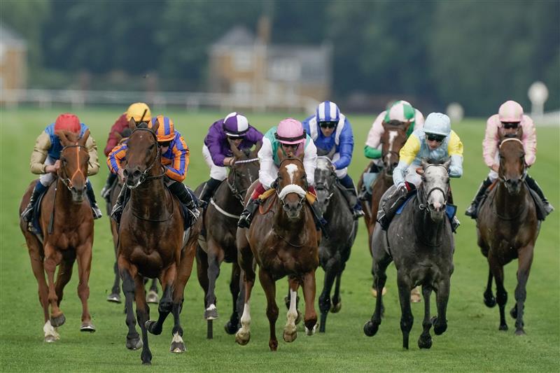 ASCOT, ENGLAND - JUNE 20: Ryan Moore riding Paddington (L, orange/blue) win The St James's Palace Stakes on day one during Royal Ascot 2023 at Ascot Racecourse on June 20, 2023 in Ascot, England. (Photo by Alan Crowhurst/Getty Images for Ascot Racecourse)