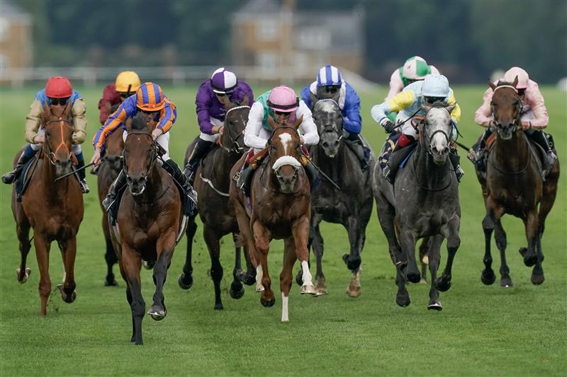 ASCOT, ENGLAND - JUNE 20: Ryan Moore riding Paddington (L, orange/blue) win The St James's Palace Stakes on day one during Royal Ascot 2023 at Ascot Racecourse on June 20, 2023 in Ascot, England. (Photo by Alan Crowhurst/Getty Images for Ascot Racecourse)