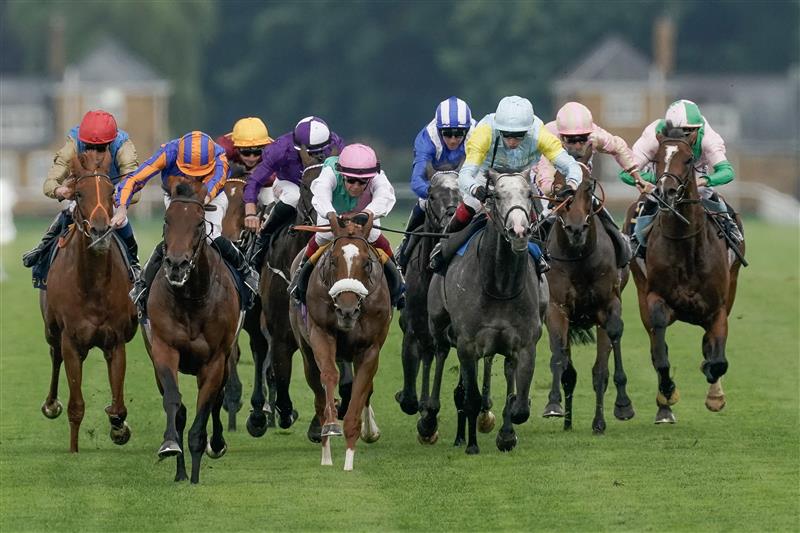 ASCOT, ENGLAND - JUNE 20: Ryan Moore riding Paddington (L, orange/blue) win The St James's Palace Stakes on day one during Royal Ascot 2023 at Ascot Racecourse on June 20, 2023 in Ascot, England. (Photo by Alan Crowhurst/Getty Images for Ascot Racecourse)