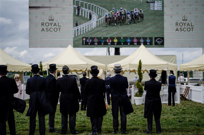 ASCOT, ENGLAND - JUNE 21: Racegoers keep an eye on the big screen on day two during Royal Ascot 2023 at Ascot Racecourse on June 21, 2023 in Ascot, England. (Photo by Alan Crowhurst/Getty Images for Ascot Racecourse)