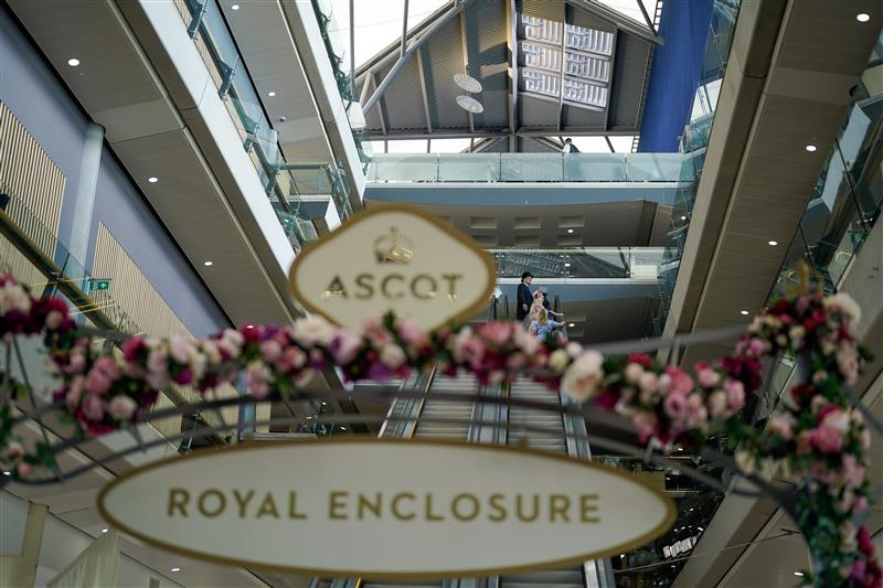 ASCOT, ENGLAND - JUNE 21: On the escalator on day two during Royal Ascot 2023 at Ascot Racecourse on June 21, 2023 in Ascot, England. (Photo by Alan Crowhurst/Getty Images for Ascot Racecourse)