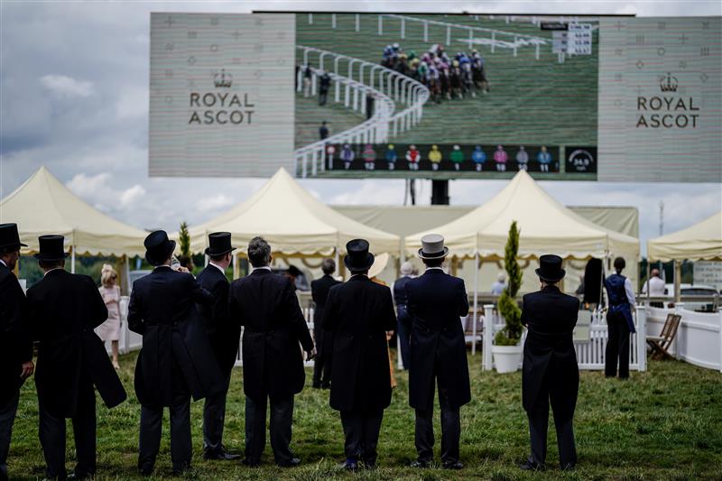 ASCOT, ENGLAND - JUNE 21: Racegoers keep an eye on the big screen on day two during Royal Ascot 2023 at Ascot Racecourse on June 21, 2023 in Ascot, England. (Photo by Alan Crowhurst/Getty Images for Ascot Racecourse)