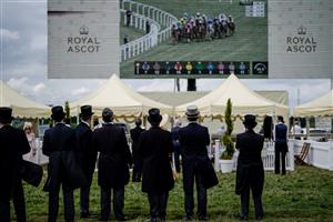 ASCOT, ENGLAND - JUNE 21: Racegoers keep an eye on the big screen on day two during Royal Ascot 2023 at Ascot Racecourse on June 21, 2023 in Ascot, England. (Photo by Alan Crowhurst/Getty Images for Ascot Racecourse)