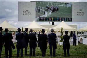 ASCOT, ENGLAND - JUNE 21: Racegoers keep an eye on the big screen on day two during Royal Ascot 2023 at Ascot Racecourse on June 21, 2023 in Ascot, England. (Photo by Alan Crowhurst/Getty Images for Ascot Racecourse)