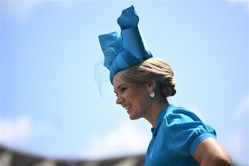 A racegoer smiles in the summer sunshine on Ladies Day, the third day of the Royal Ascot horse racing meeting in Ascot, west of London, on June 22, 2023. (Photo by JUSTIN TALLIS / AFP) (Photo by JUSTIN TALLIS/AFP via Getty Images)