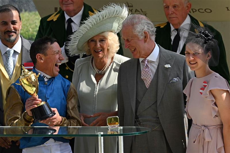 Jockey Frankie Dettori (2L) shares a joke with Britain