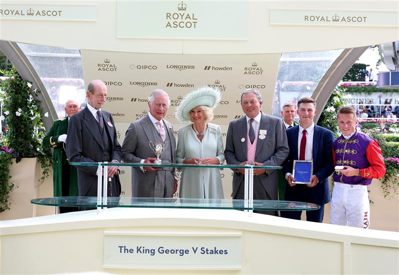 ASCOT, ENGLAND - JUNE 22: Owners of Desert Hero, King Charles III and Queen Camilla collect the winners trophy for The King George V Stakes alongside trainer William Haggas, and jockey Tom Marquand during day three of Royal Ascot 2023 at Ascot Racecourse on June 22, 2023 in Ascot, England. (Photo by Tom Dulat/Getty Images for Ascot Racecourse)