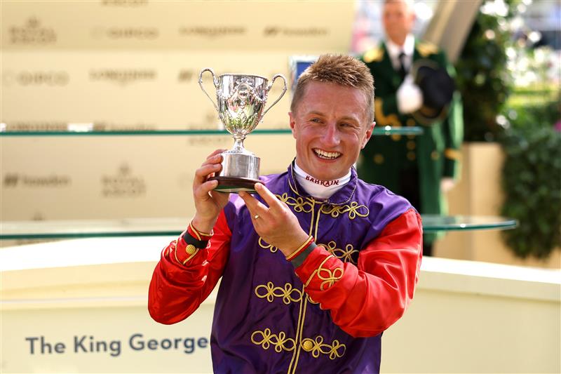 ASCOT, ENGLAND - JUNE 22:  Tom Marquand riding Desert Hero poses with the trophy after winning The King George V Stakes  during day three of Royal Ascot 2023 at Ascot Racecourse on June 22, 2023 in Ascot, England. (Photo by Alex Pantling/Getty Images)