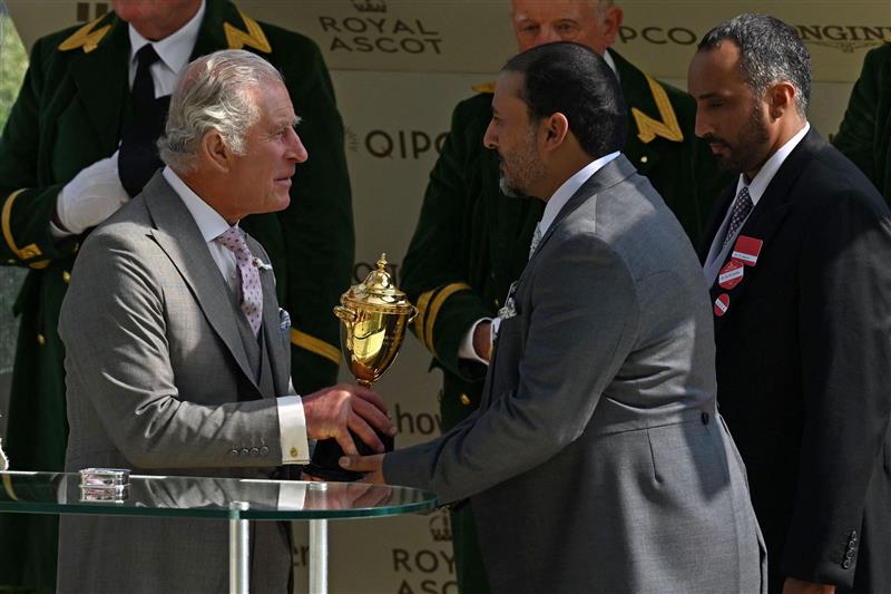 A representative of the owners, Wathnan Racing receives the Gold Cup trophy from Britain