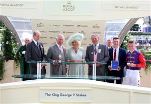 ASCOT, ENGLAND - JUNE 22: Owners of Desert Hero, King Charles III and Queen Camilla collect the winners trophy for The King George V Stakes alongside trainer William Haggas, and jockey Tom Marquand during day three of Royal Ascot 2023 at Ascot Racecourse on June 22, 2023 in Ascot, England. (Photo by Tom Dulat/Getty Images for Ascot Racecourse)