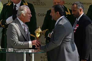 A representative of the owners, Wathnan Racing receives the Gold Cup trophy from Britain