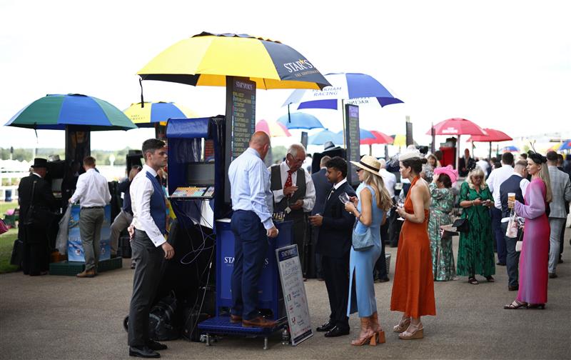 Racegoers queue to place a bet ahead of racing on the final day of the Royal Ascot horse racing meeting in Ascot, west of London, on June 24, 2023. (Photo by HENRY NICHOLLS / AFP) (Photo by HENRY NICHOLLS/AFP via Getty Images)