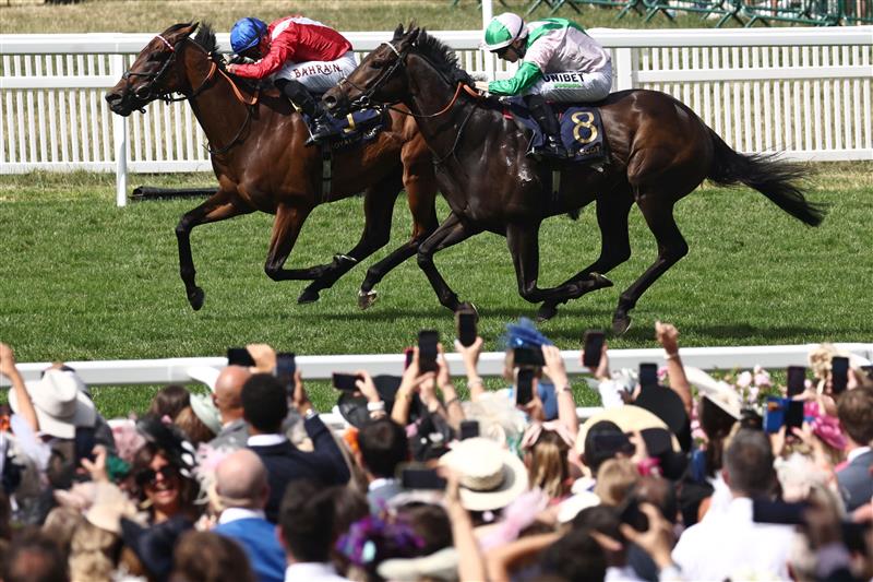 Jockey Jamie Spencer on Khaadem (R) chases down jockey Tom Marquand on Sacred (L) to win the Queen Elizabeth II Jubilee Stakes on the final day of the Royal Ascot horse racing meeting in Ascot, west of London, on June 24, 2023. (Photo by HENRY NICHOLLS / AFP) (Photo by HENRY NICHOLLS/AFP via Getty Images)