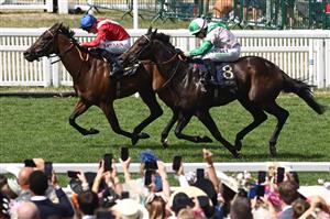 Jockey Jamie Spencer on Khaadem (R) chases down jockey Tom Marquand on Sacred (L) to win the Queen Elizabeth II Jubilee Stakes on the final day of the Royal Ascot horse racing meeting in Ascot, west of London, on June 24, 2023. (Photo by HENRY NICHOLLS / AFP) (Photo by HENRY NICHOLLS/AFP via Getty Images)