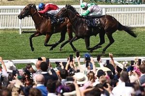 Jockey Jamie Spencer on Khaadem (R) chases down jockey Tom Marquand on Sacred (L) to win the Queen Elizabeth II Jubilee Stakes on the final day of the Royal Ascot horse racing meeting in Ascot, west of London, on June 24, 2023. (Photo by HENRY NICHOLLS / AFP) (Photo by HENRY NICHOLLS/AFP via Getty Images)