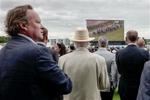 CHICHESTER, ENGLAND - AUGUST 04: Racegoers watch the racing at Goodwood Racecourse on August 04, 2023 in Chichester, England. (Photo by Alan Crowhurst/Getty Images)