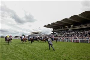 CHICHESTER, ENGLAND - AUGUST 04: Starter Sam Avis chases up the runners at the start for The Coral Goodwood Handicap at Goodwood Racecourse on August 04, 2023 in Chichester, England. (Photo by Alan Crowhurst/Getty Images)