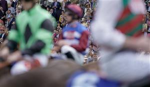 CHICHESTER, ENGLAND - AUGUST 04: Racegoers look on as runners circle at the start for The Coral Goodwood Handicap at Goodwood Racecourse on August 04, 2023 in Chichester, England. (Photo by Alan Crowhurst/Getty Images)