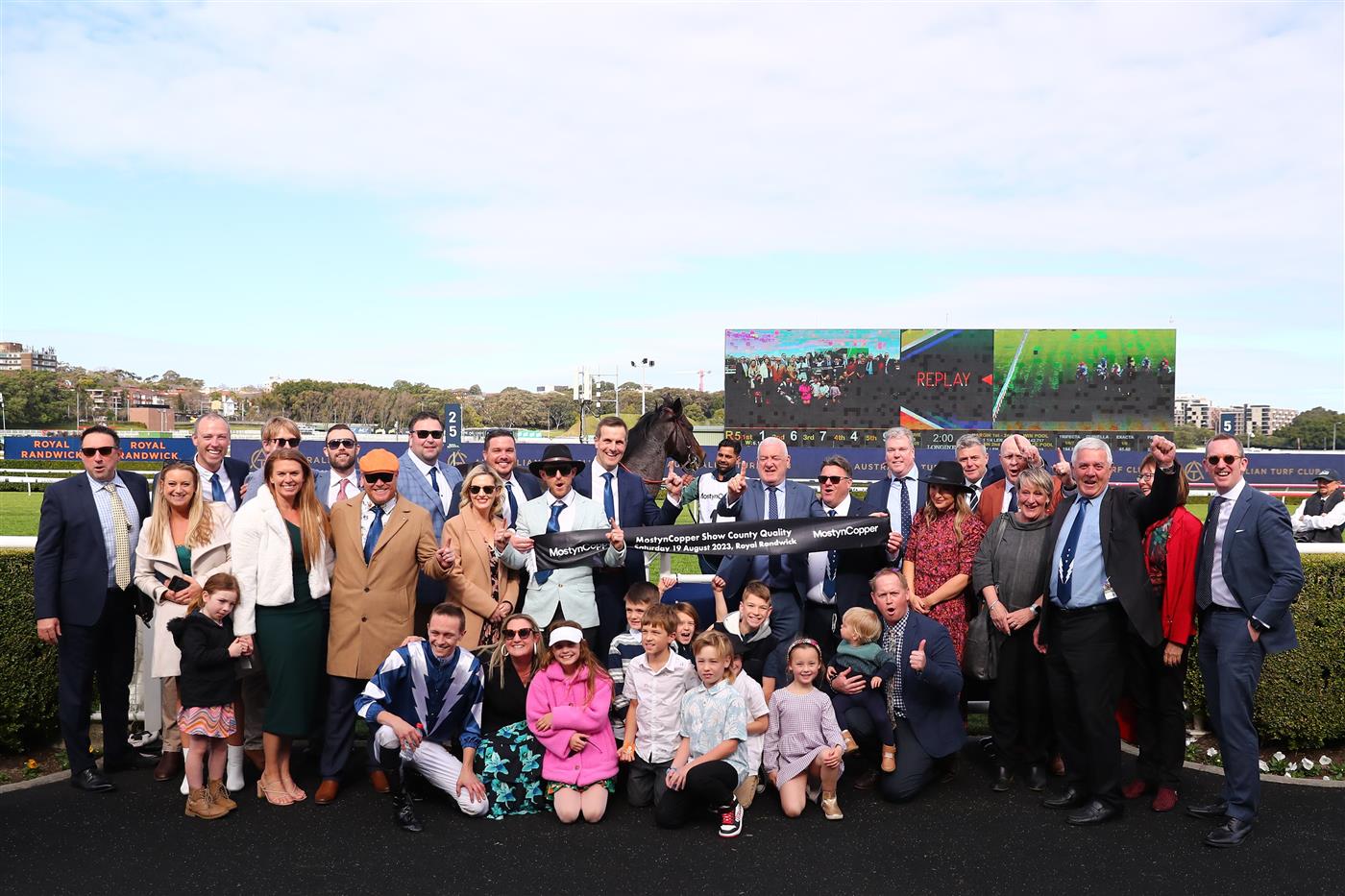 SYDNEY, AUSTRALIA - AUGUST 19:  Trainer Matthew Smith celebrates with owners and VIPs after Dylan Gibbons riding Buenos Noches wins Race 5 Mostyncopper Show County Quality during "Winx Stakes Day" - Sydney Racing at Royal Randwick Racecourse on August 19, 2023 in Sydney, Australia. (Photo by Jeremy Ng/Getty Images)