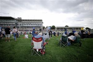 YORK, ENGLAND - AUGUST 23: Racegoers relax in the