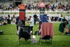 YORK, ENGLAND - AUGUST 23: Racegoers relax in the
