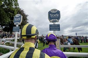 YORK, ENGLAND - AUGUST 24: Jockeys enter the parade ring at York Racecourse on August 24, 2023 in York, England. (Photo by Alan Crowhurst/Getty Images)