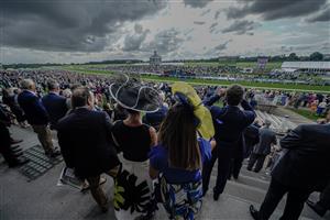 YORK, ENGLAND - AUGUST 24: Racegoers wach from the grandstand at York Racecourse on August 24, 2023 in York, England. (Photo by Alan Crowhurst/Getty Images)
