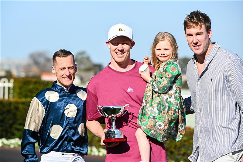 MELBOURNE, AUSTRALIA - SEPTEMBER 02: Winning connections Jack Riewoldt and daughter Poppy Riewoldt and Tom Lynch pose with Blake Shinn after Soulcombe won Race 6, the Tile Importer Heatherlie Stakes, during Melbourne Racing at Caulfield Racecourse on September 02, 2023 in Melbourne, Australia. (Photo by Vince Caligiuri/Getty Images)