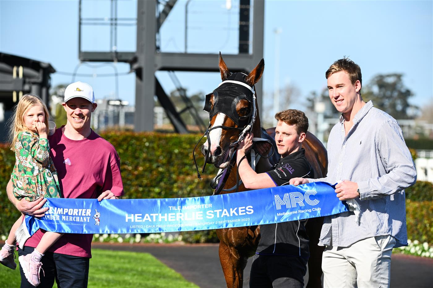 MELBOURNE, AUSTRALIA - SEPTEMBER 02: Winning connections Jack Riewoldt and daughter Poppy Riewoldt and Tom Lynch pose after Soulcombe won Race 6, the Tile Importer Heatherlie Stakes, during Melbourne Racing at Caulfield Racecourse on September 02, 2023 in Melbourne, Australia. (Photo by Vince Caligiuri/Getty Images)