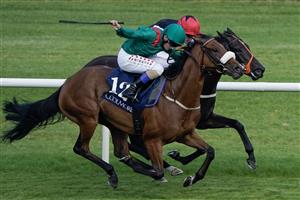 DUBLIN, IRELAND - SEPTEMBER 09: Chris Hayes riding Tahiyra (green) win The Coolmore America