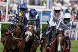 DONCASTER, ENGLAND - SEPTEMBER 15: Hollie Doyle riding Trueshan (blue/yellow) on their way to winning The Betfred Doncaster Cup Stakes at Doncaster Racecourse on September 15, 2023 in Doncaster, England. (Photo by Alan Crowhurst/Getty Images)