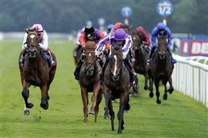 DONCASTER, ENGLAND - SEPTEMBER 16: Ryan Moore riding Continuous (purple/white) win The Betfred St Leger Stakes at Doncaster Racecourse on September 16, 2023 in Doncaster, England. (Photo by Alan Crowhurst/Getty Images)