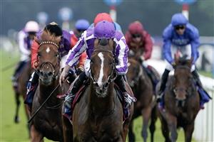 DONCASTER, ENGLAND - SEPTEMBER 16: Ryan Moore riding Continuous (purple/white) win The Betfred St Leger Stakes at Doncaster Racecourse on September 16, 2023 in Doncaster, England. (Photo by Alan Crowhurst/Getty Images)