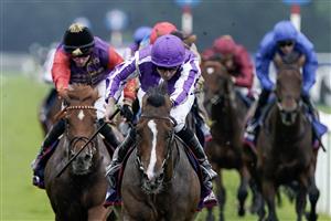 DONCASTER, ENGLAND - SEPTEMBER 16: Ryan Moore riding Continuous (purple/white) win The Betfred St Leger Stakes at Doncaster Racecourse on September 16, 2023 in Doncaster, England. (Photo by Alan Crowhurst/Getty Images)