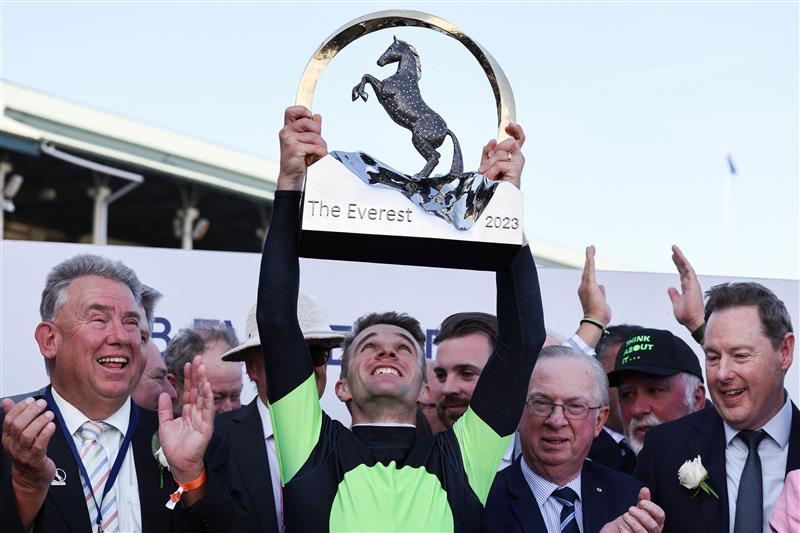 Jockey Sam Clipperton (C), rider of Australian sprinter Think About It, lifts the Everest trophy after winning the The TAB Everest during Sydney Racing at Royal Randwick Racecourse on October 14, 2023 in Sydney, Australia. (Getty)