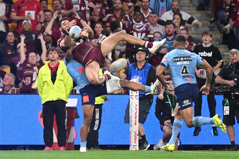 BRISBANE, AUSTRALIA - MAY 28: Xavier Coates of the Maroons is tackled without the ball by Brian To