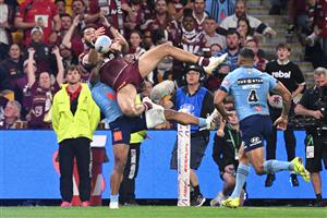 BRISBANE, AUSTRALIA - MAY 28: Xavier Coates of the Maroons is tackled without the ball by Brian To